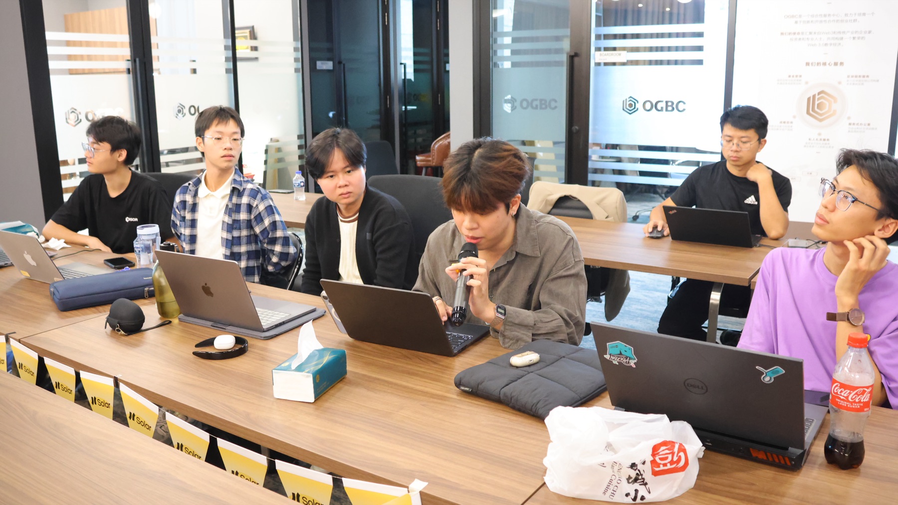 Solar Cypherpunk builders working around a table